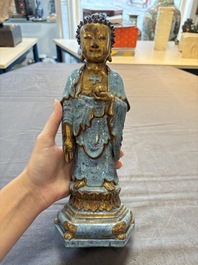 A Chinese robin's egg-glazed gilt-decorated standing Buddha, 18th C.
