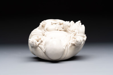 A Chinese green-enamelled lotus leaf-shaped brush washer and a Dehua blanc de Chine Milefo Buddha, 19th C