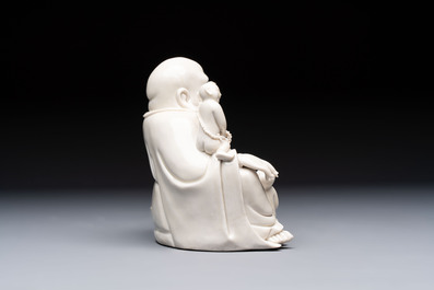 A Chinese green-enamelled lotus leaf-shaped brush washer and a Dehua blanc de Chine Milefo Buddha, 19th C
