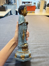 A Chinese robin's egg-glazed gilt-decorated standing Buddha, 18th C.