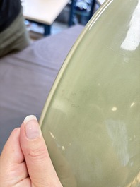 A rare and large Chinese Longquan celadon 'lotus bouquet' dish, Ming, early 15th C.
