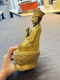 A Tibetan gilt-bronze figure of Padmasambhava holding a cup and a vajra, 17th C. or later
