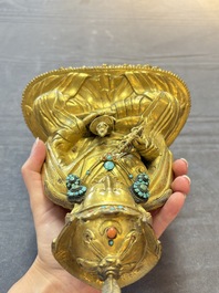 A Tibetan gilt-bronze figure of Padmasambhava holding a cup and a vajra, 17th C. or later