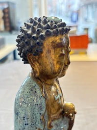 A Chinese robin's egg-glazed gilt-decorated standing Buddha, 18th C.