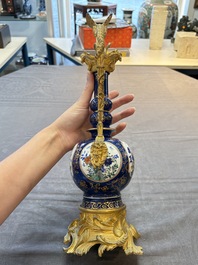 A pair of gilt-bronze-mounted Chinese famille verte powder-blue-ground double gourd vases, 19th C.