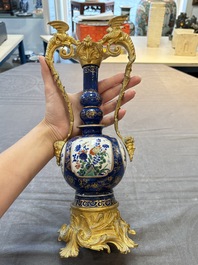 A pair of gilt-bronze-mounted Chinese famille verte powder-blue-ground double gourd vases, 19th C.