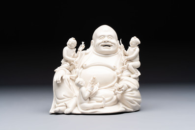 A Chinese green-enamelled lotus leaf-shaped brush washer and a Dehua blanc de Chine Milefo Buddha, 19th C