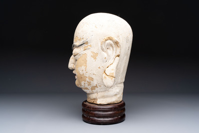 A Chinese stucco head of a Luohan, Qing