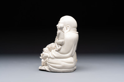 A Chinese green-enamelled lotus leaf-shaped brush washer and a Dehua blanc de Chine Milefo Buddha, 19th C