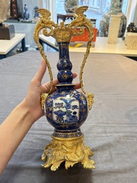 A pair of gilt-bronze-mounted Chinese famille verte powder-blue-ground double gourd vases, 19th C.