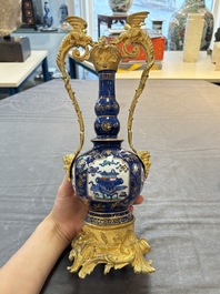 A pair of gilt-bronze-mounted Chinese famille verte powder-blue-ground double gourd vases, 19th C.