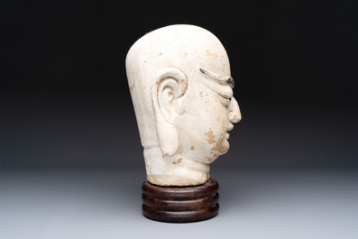 A Chinese stucco head of a Luohan, Qing