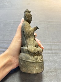 A Chinese bronze Taoist figure and a gilt-lacquered guardian, Ming