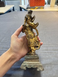 A Chinese bronze Taoist figure and a gilt-lacquered guardian, Ming