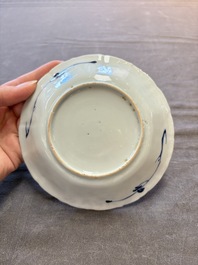 A set of 11 Chinese blue and white cups and saucers with riverscape design, Kangxi