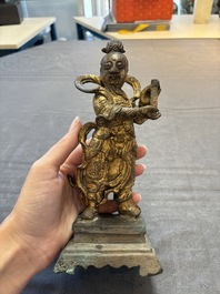 A Chinese bronze Taoist figure and a gilt-lacquered guardian, Ming