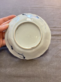 A set of 11 Chinese blue and white cups and saucers with riverscape design, Kangxi