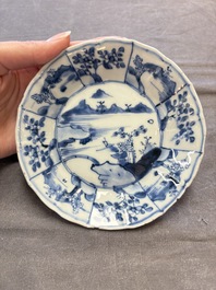 A set of 11 Chinese blue and white cups and saucers with riverscape design, Kangxi