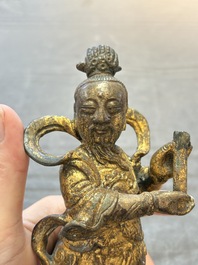 A Chinese bronze Taoist figure and a gilt-lacquered guardian, Ming