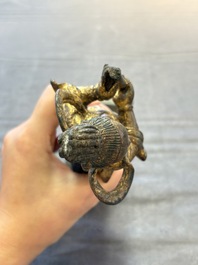 A Chinese bronze Taoist figure and a gilt-lacquered guardian, Ming