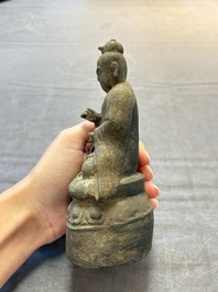 A Chinese bronze Taoist figure and a gilt-lacquered guardian, Ming