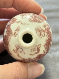 A Chinese blue, white and copper-red 'dragon' snuff bottle, 19th C.