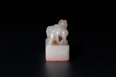 A Chinese celadon and russet jade 'chilong' seal, 18/19th C.