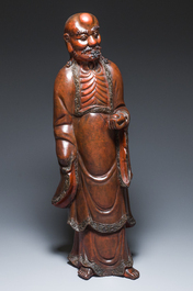 A large Japanese lacquered wooden figure of Daruma, Meiji, 19th C.