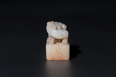 A Chinese celadon and russet jade 'chilong' seal, 18/19th C.
