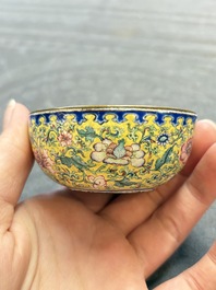 A pair of Chinese yellow-ground Canton enamel covered bowls and two cups, Yongzheng/Qianlong