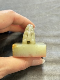 A Chinese celadon and russet jade 'dragon' seal, 18/19th C.