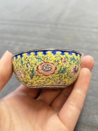 A pair of Chinese yellow-ground Canton enamel covered bowls and two cups, Yongzheng/Qianlong