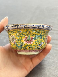 A pair of Chinese yellow-ground Canton enamel covered bowls and two cups, Yongzheng/Qianlong