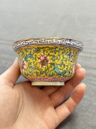 A pair of Chinese yellow-ground Canton enamel covered bowls and two cups, Yongzheng/Qianlong