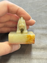 A Chinese celadon and russet jade 'dragon' seal, 18/19th C.