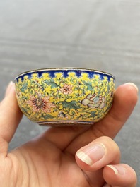 A pair of Chinese yellow-ground Canton enamel covered bowls and two cups, Yongzheng/Qianlong