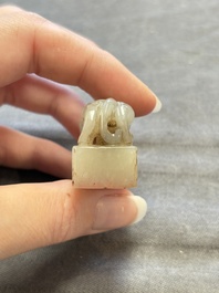 A Chinese celadon and russet jade 'chilong' seal, 18/19th C.