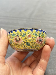 A pair of Chinese yellow-ground Canton enamel covered bowls and two cups, Yongzheng/Qianlong