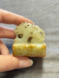 A Chinese celadon and russet jade 'dragon' seal, 18/19th C.
