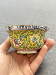 A pair of Chinese yellow-ground Canton enamel covered bowls and two cups, Yongzheng/Qianlong