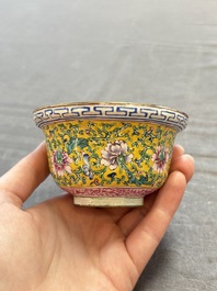A pair of Chinese yellow-ground Canton enamel covered bowls and two cups, Yongzheng/Qianlong