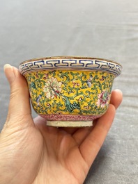 A pair of Chinese yellow-ground Canton enamel covered bowls and two cups, Yongzheng/Qianlong