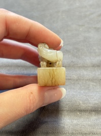 A Chinese celadon and russet jade 'chilong' seal, 18/19th C.