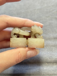 A Chinese celadon and russet jade 'chilong' seal, 18/19th C.