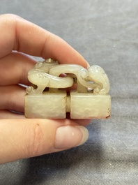 A Chinese celadon and russet jade 'chilong' seal, 18/19th C.