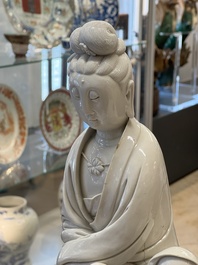 A rare and elegant Chinese Dehua blanc de Chine Guanyin on a wooden stand, Transitional period