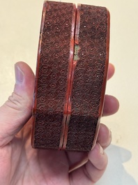 A fine Chinese red cinnabar lacquer ruyi-form 'Ba Man Xian Bao 八蠻獻寶' box and cover, Qianlong