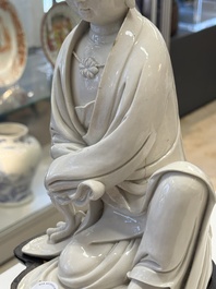 A rare and elegant Chinese Dehua blanc de Chine Guanyin on a wooden stand, Transitional period