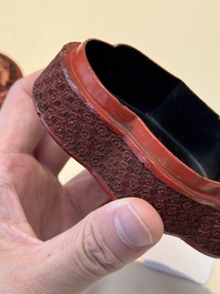 A fine Chinese red cinnabar lacquer ruyi-form 'Ba Man Xian Bao 八蠻獻寶' box and cover, Qianlong