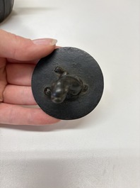 A Chinese bronze teapot and cover with a lion-shaped finial, Yuan